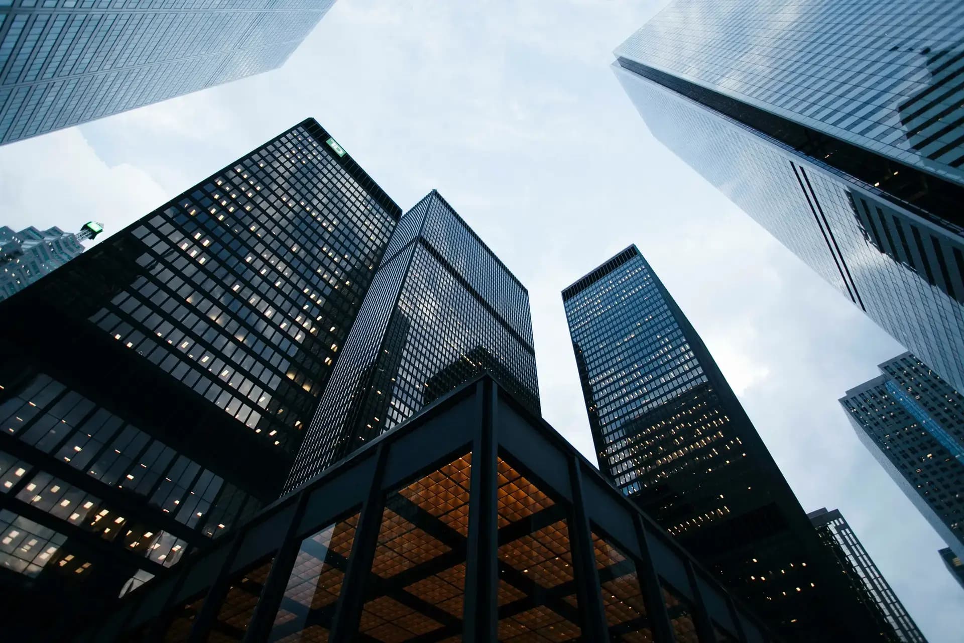 Modern skyscrapers viewed from below against a cloudy sky